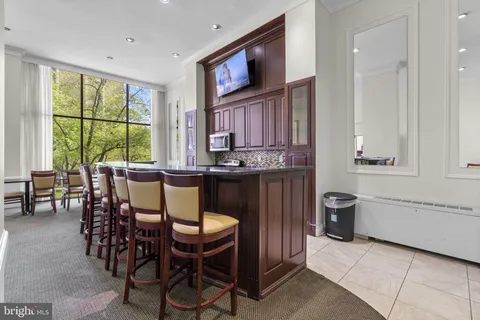 a dining room with furniture and window