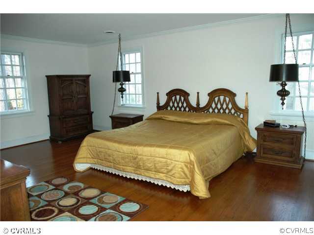 10319 Cherokee Road Richmond, VA 23235 - Photo 11 of 12 a bedroom with a bed and a flat tv screen on dresser