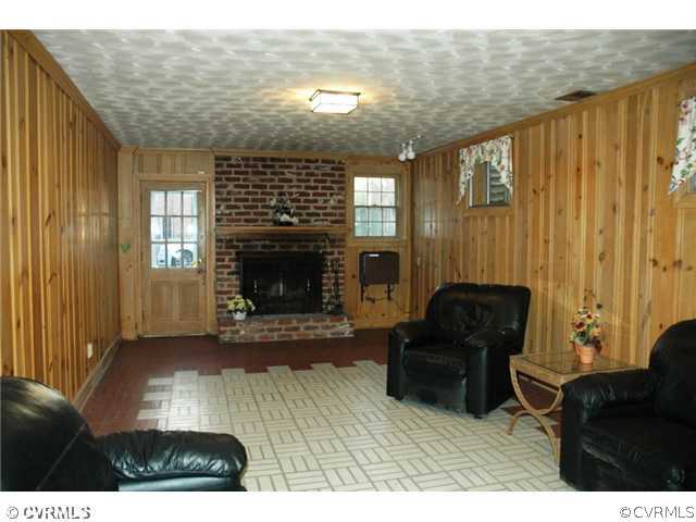 10319 Cherokee Road Richmond, VA 23235 - Photo 12 of 12 a living room with furniture and a fireplace