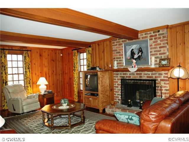 10319 Cherokee Road Richmond, VA 23235 - Photo 7 of 12 a living room with furniture a fireplace and a large window