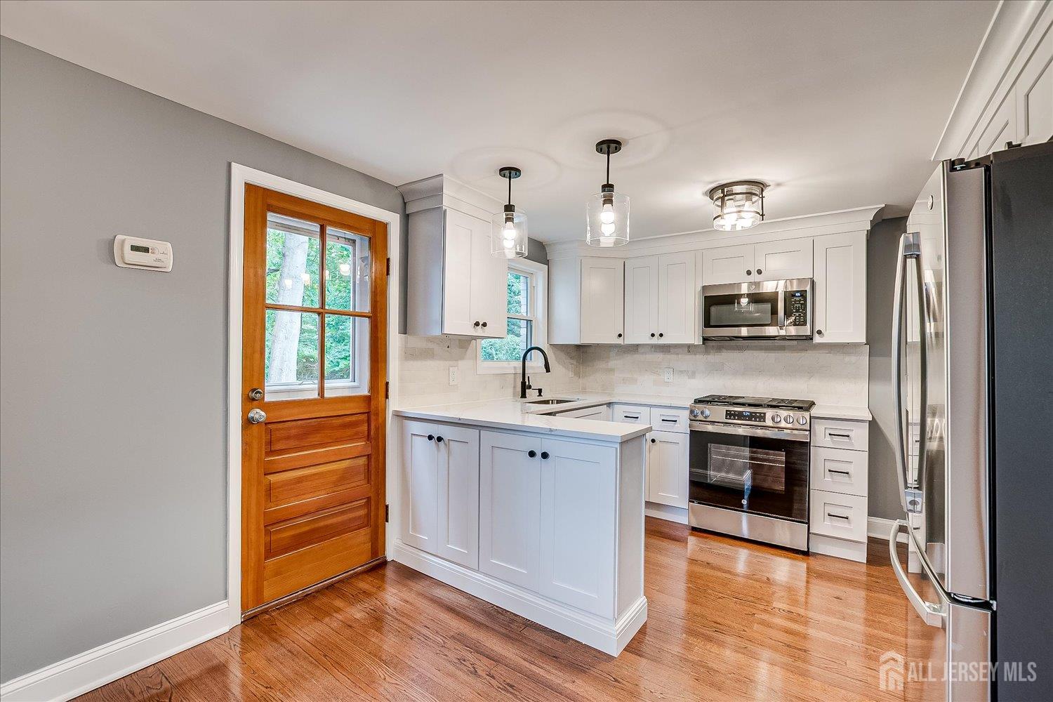 32 Kate Lane Metuchen, NJ 08840 - Photo 13 of 31 a large kitchen with stainless steel appliances granite countertop a stove a sink dishwasher and a refrigerator