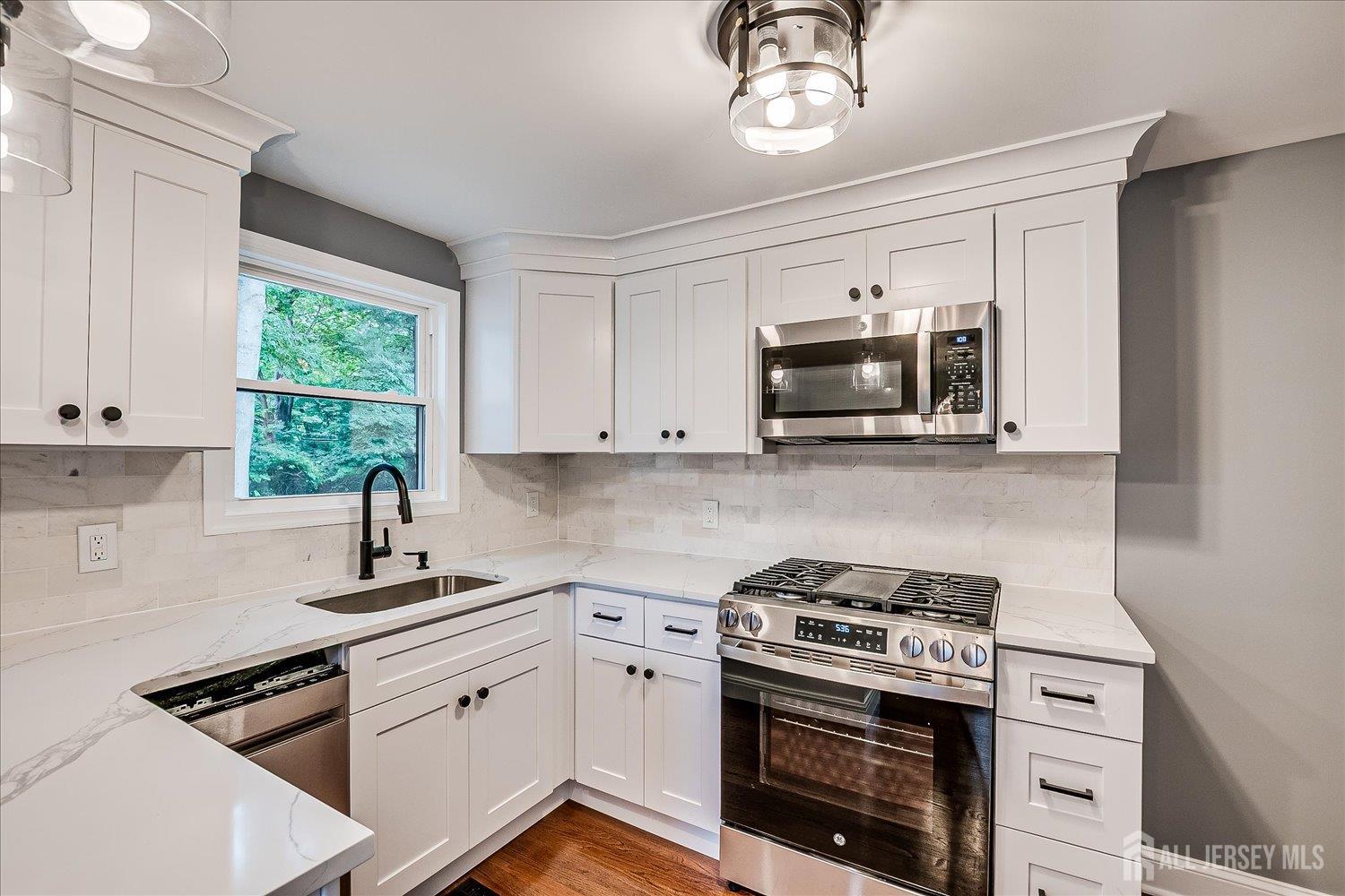 32 Kate Lane Metuchen, NJ 08840 - Photo 15 of 31 a kitchen with granite countertop a stove and a sink