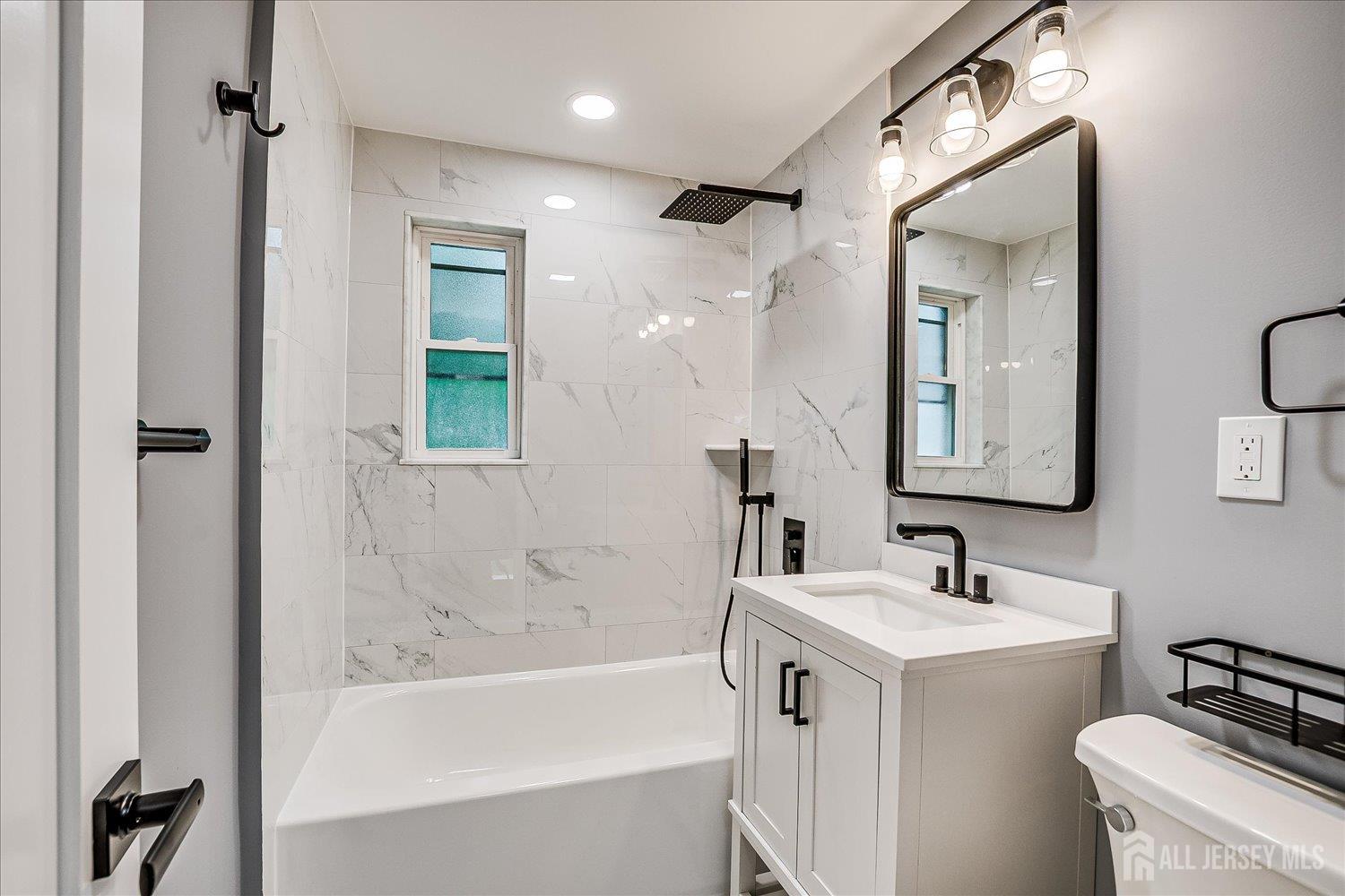 32 Kate Lane Metuchen, NJ 08840 - Photo 23 of 31 a bathroom with a sink a toilet and shower