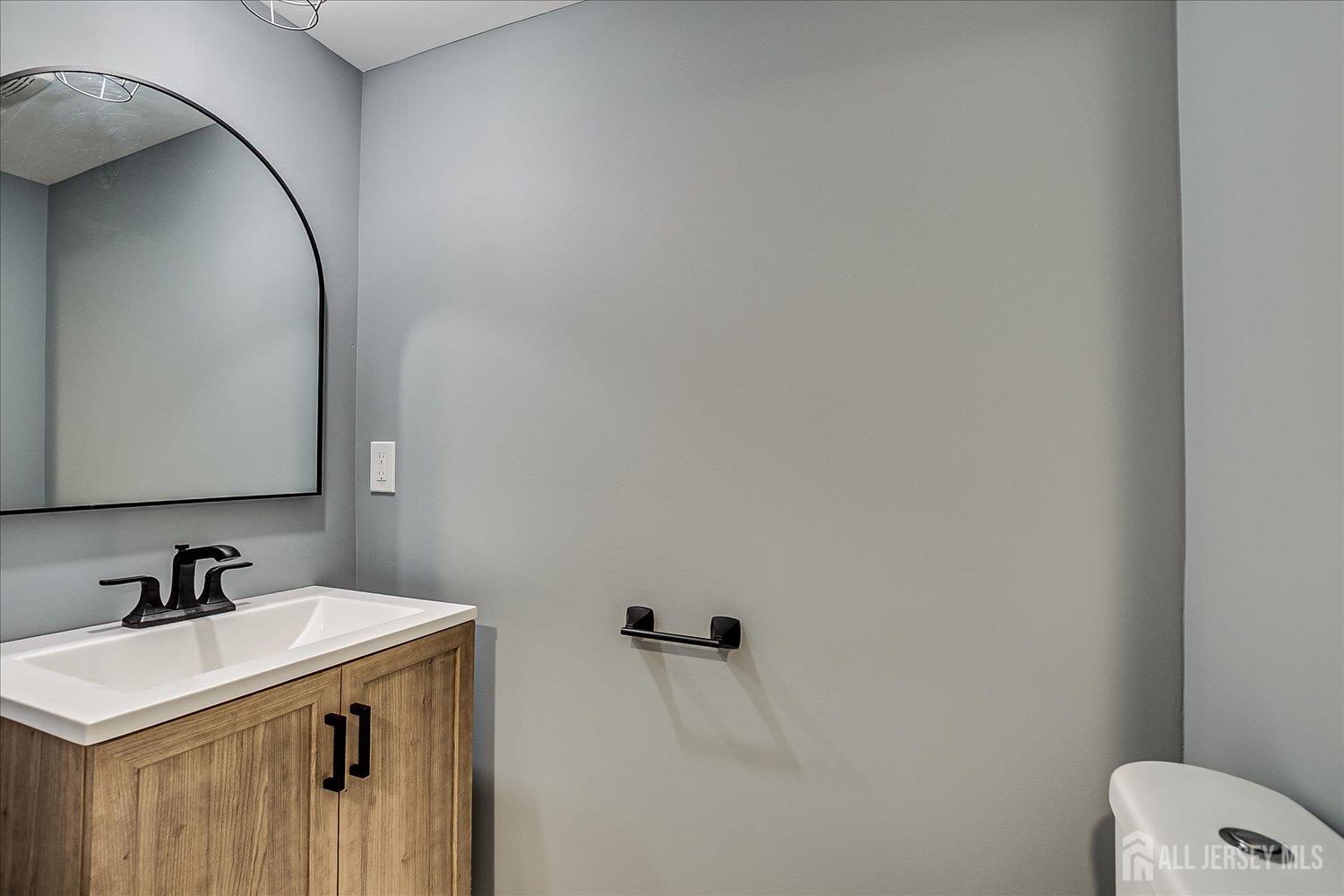 32 Kate Lane Metuchen, NJ 08840 - Photo 26 of 31 a bathroom with a sink and mirror