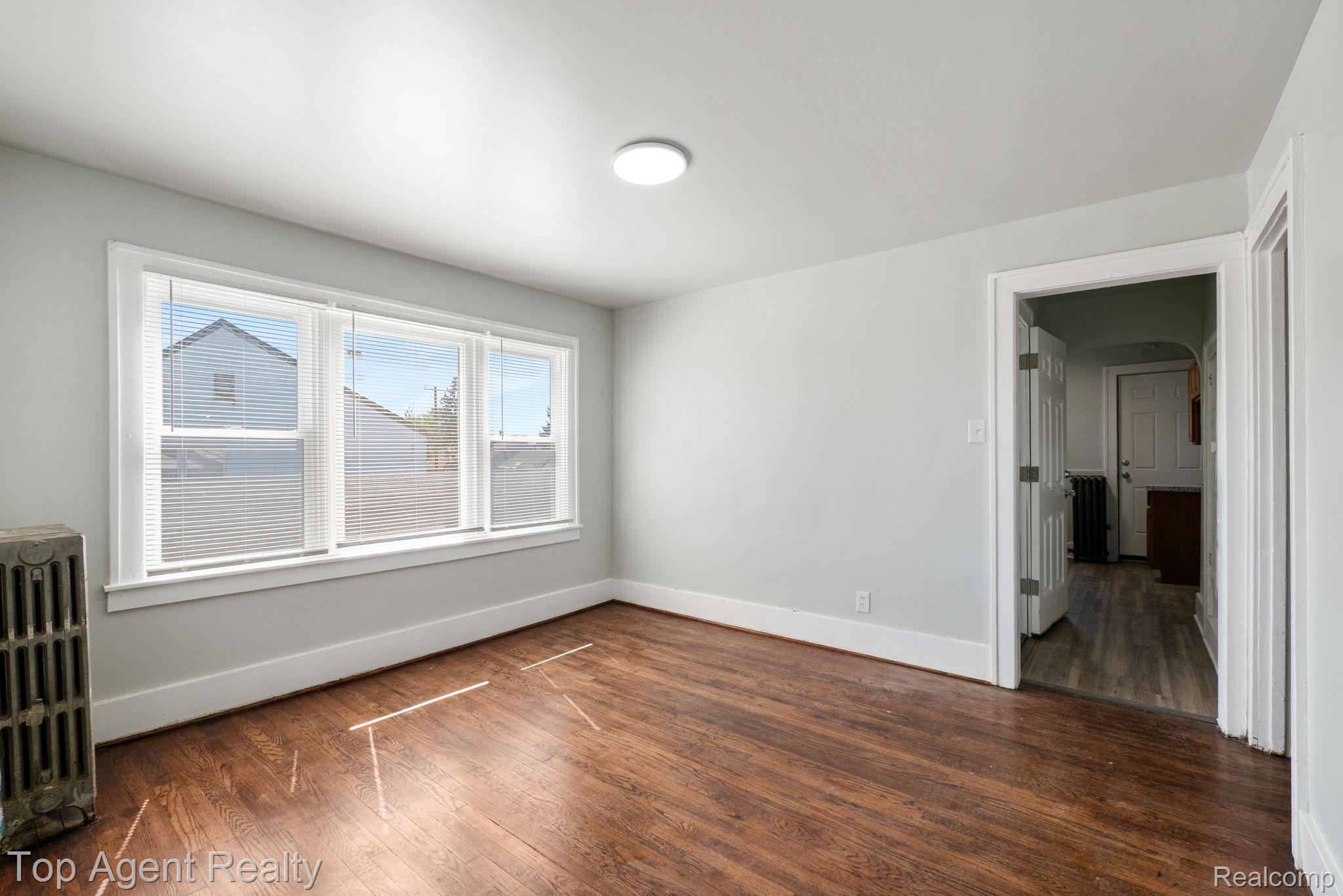 19217 Reno Street Detroit, MI 48205 - Photo 32 of 45 Hardwood-finish flooring, white trim, multiple windows with blinds, and ceiling-mounted lighting