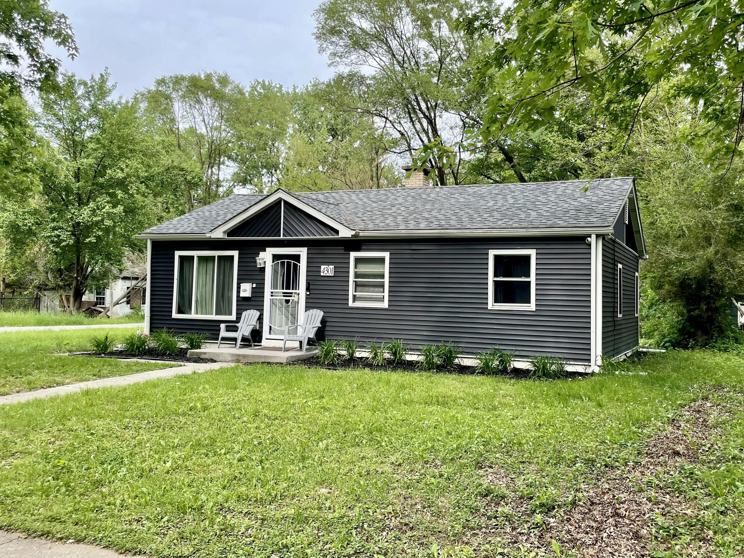 4301 Johnson Street Gary, IN 46408 - Photo 16 of 16 a front view of a house with a yard and porch