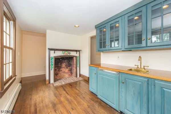 a hallway view with wooden floor and staircase