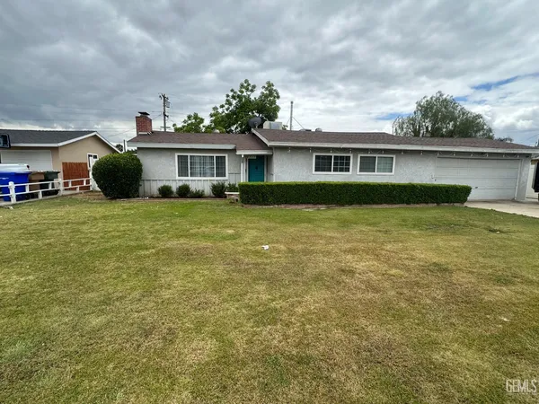 a view of a house with a yard and sitting area
