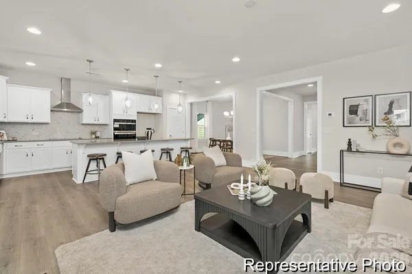 a living room with furniture kitchen and a table