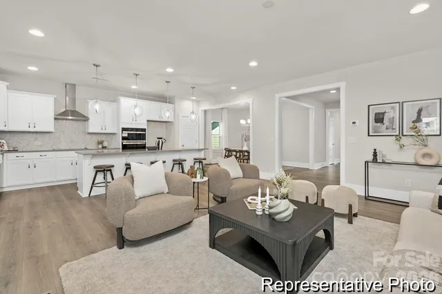 a living room with furniture kitchen and a table