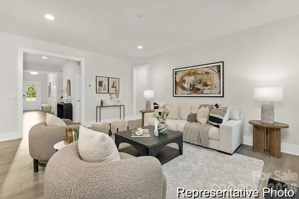 a living room with furniture potted plant and white walls