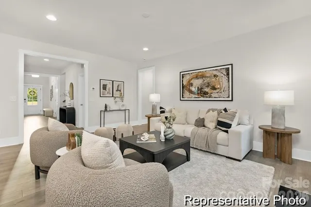 a living room with furniture potted plant and white walls