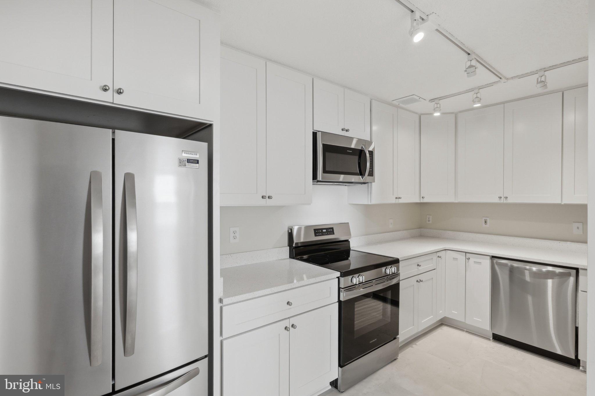 1101 St Paul Street, Unit 1212 Baltimore, MD 21202 - Photo 11 of 36 Sleek modern kitchen with stainless steel.