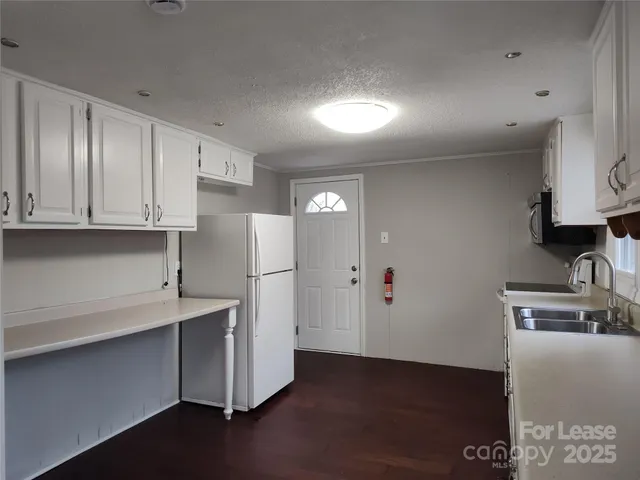 a kitchen with stainless steel appliances a refrigerator and a stove top oven