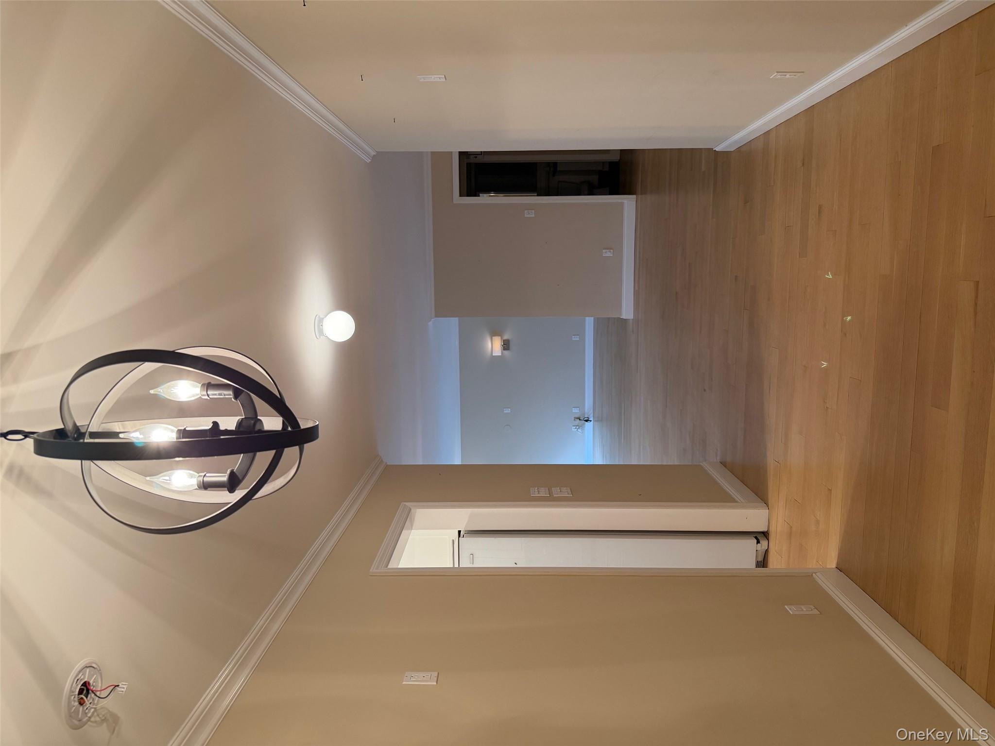 420 East 51st Street, Unit 8DE Manhattan, NY 10022 - Photo 12 of 17 a view of a livingroom with a mirror and wooden floor