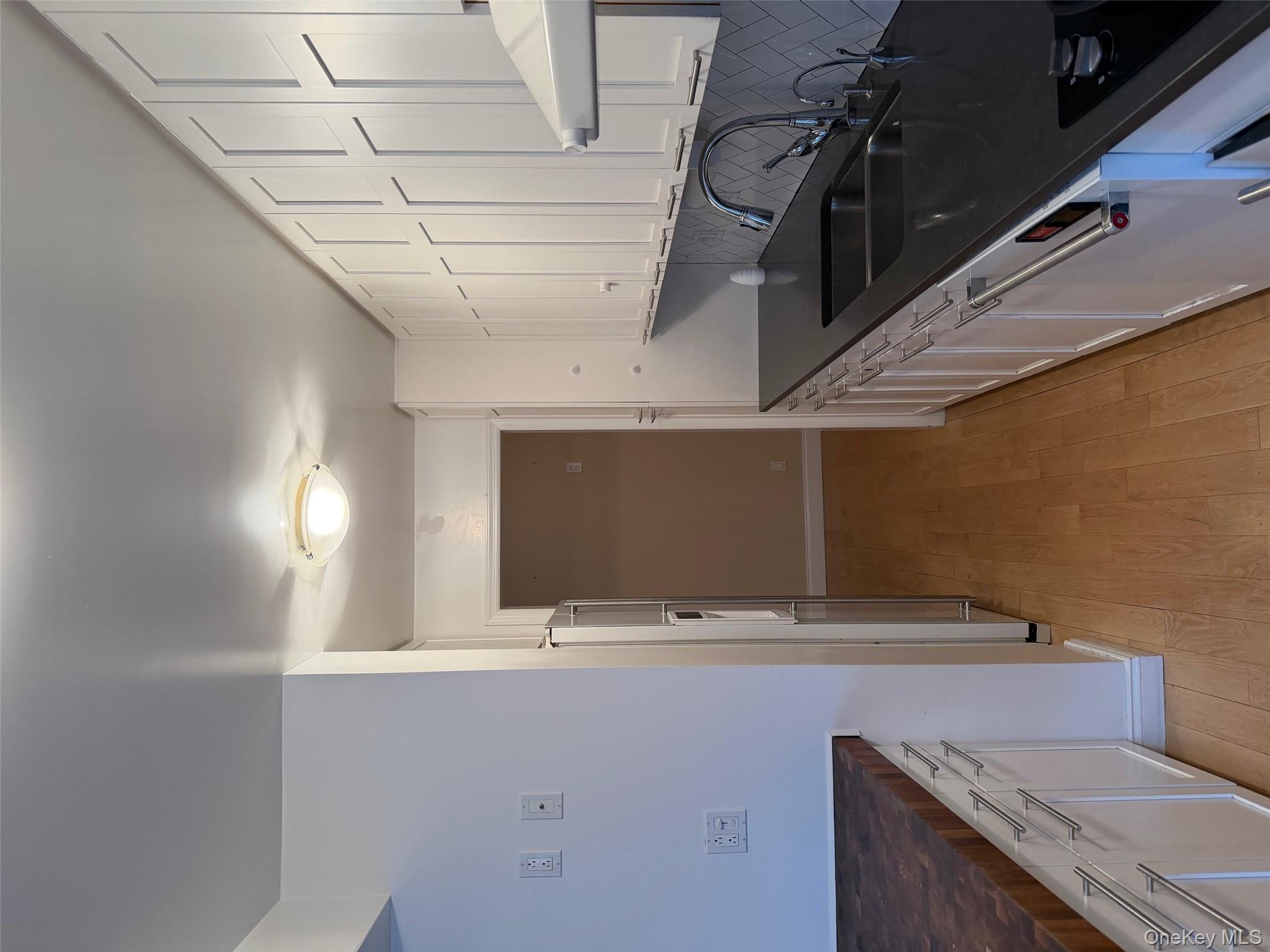 420 East 51st Street, Unit 8DE Manhattan, NY 10022 - Photo 15 of 17 a kitchen with granite countertop a sink and a stove top oven