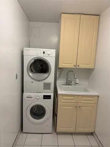 a utility room with sink dryer and washer