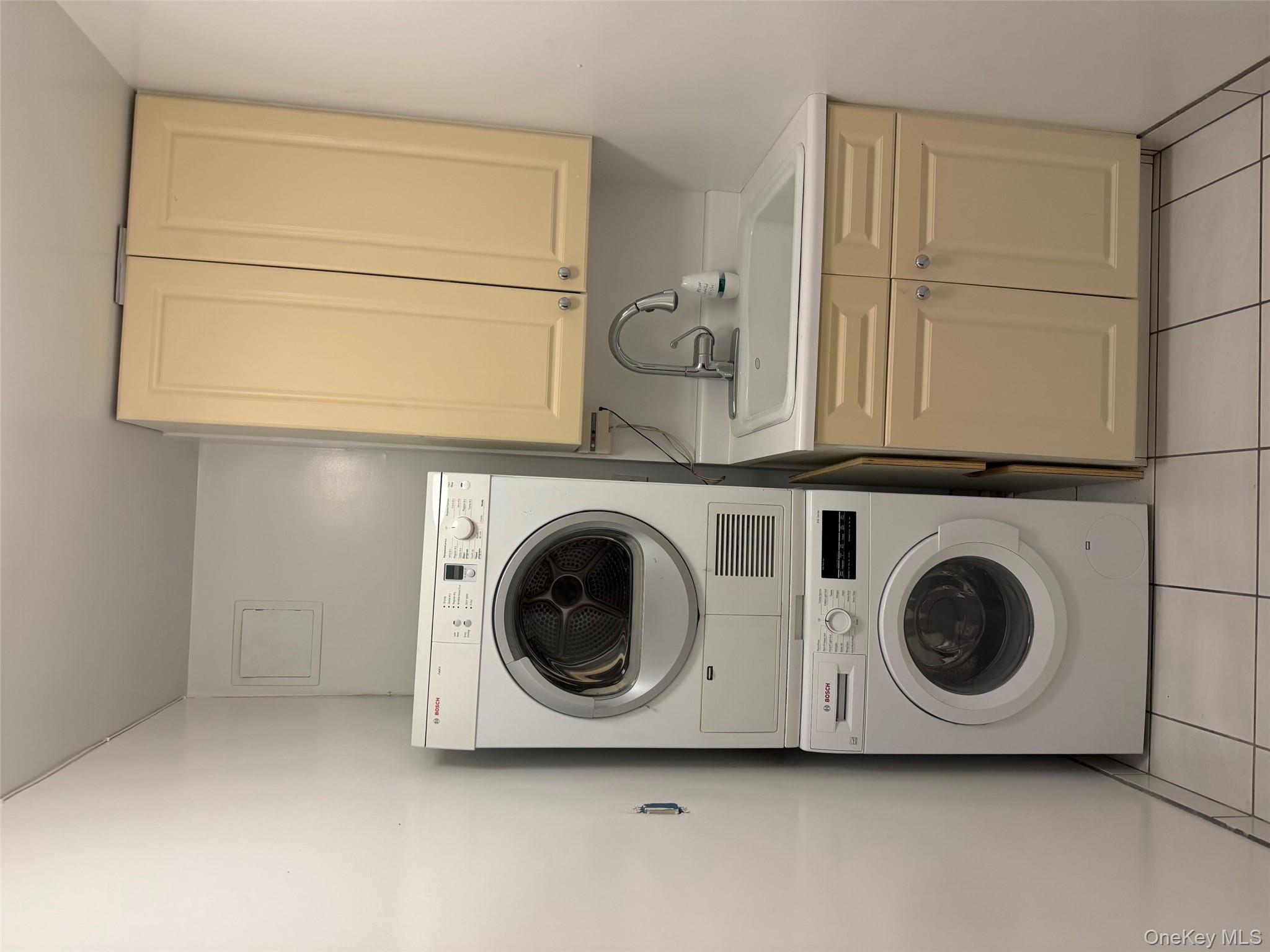 420 East 51st Street, Unit 8DE Manhattan, NY 10022 - Photo 17 of 17 a utility room with sink dryer and washer