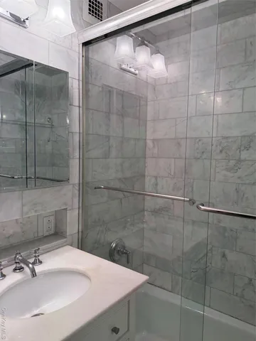 a bathroom with a shower and a sink