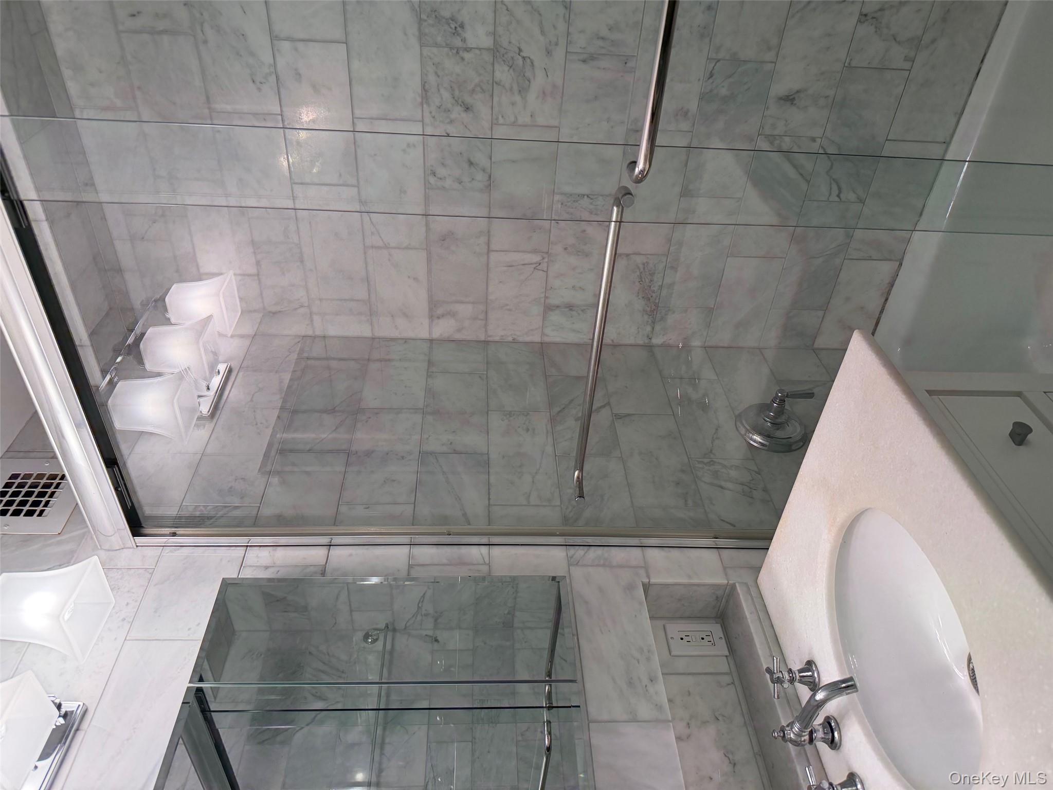 420 East 51st Street, Unit 8DE Manhattan, NY 10022 - Photo 10 of 17 a bathroom with a shower and a sink