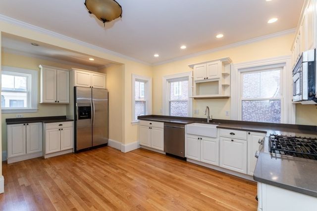 a kitchen with stainless steel appliances granite countertop a stove and a sink