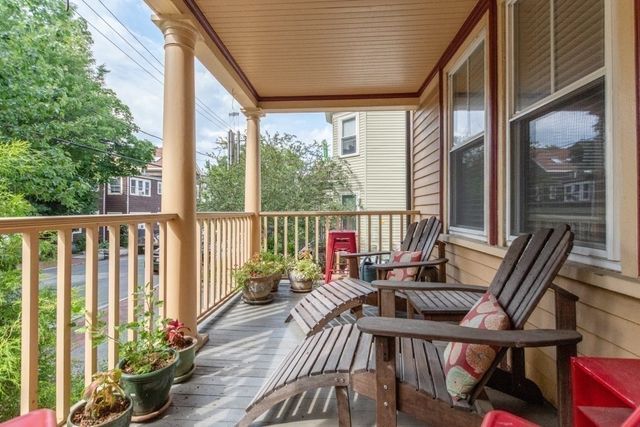 a view of a balcony with furniture