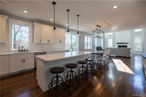 a kitchen with sink table and chairs