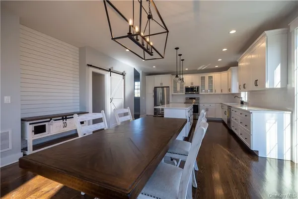 a kitchen with stainless steel appliances granite countertop a sink a stove and a refrigerator