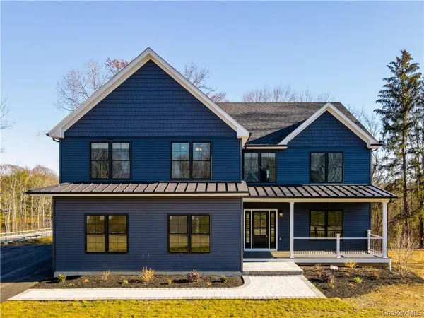 a view of a brick house with large windows