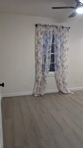 a view of a room with wooden floor and closet