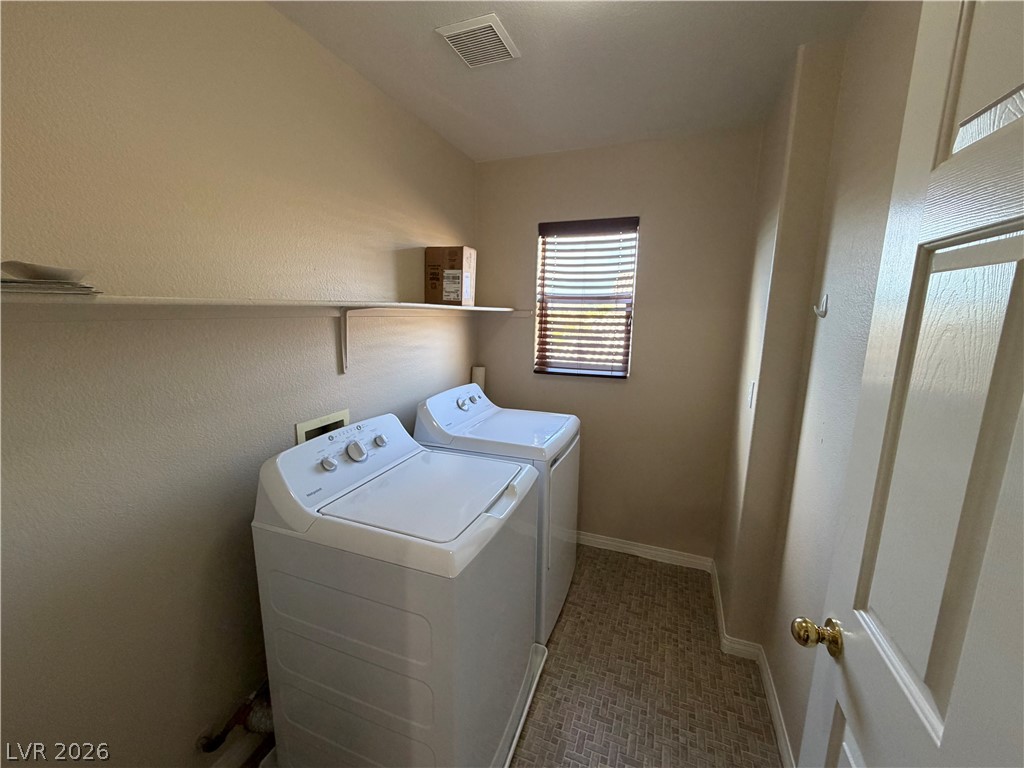 7613 Roop Street Las Vegas, NV 89131 - Photo 22 of 25 Functional laundry facilities feature practical shelving and durable flooring.