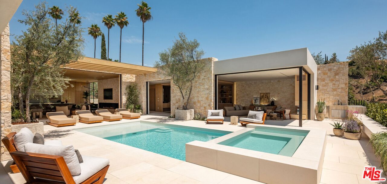 a view of a house with swimming pool and sitting area