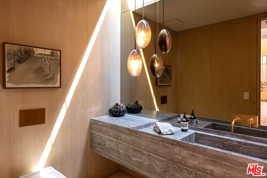 1039 Wallace Ridge Beverly Hills, CA 90210 - Photo 16 of 56 a room with a sink and mirror