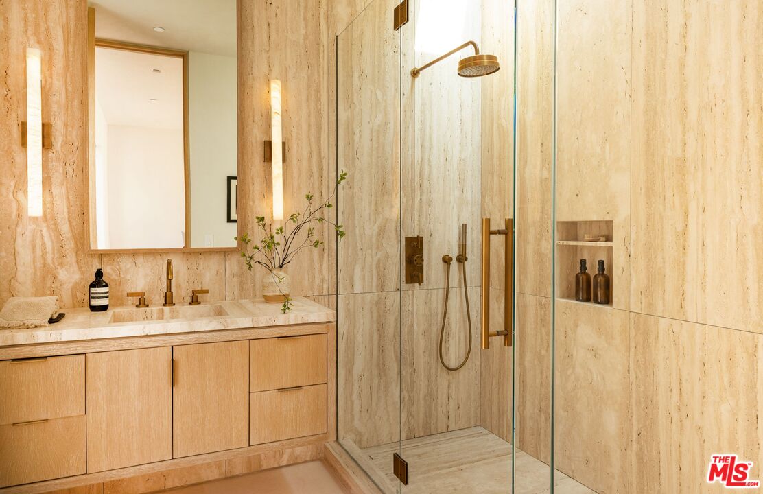 1039 Wallace Ridge Beverly Hills, CA 90210 - Photo 26 of 56 a bathroom with a double vanity sink a mirror a shower and a glass door