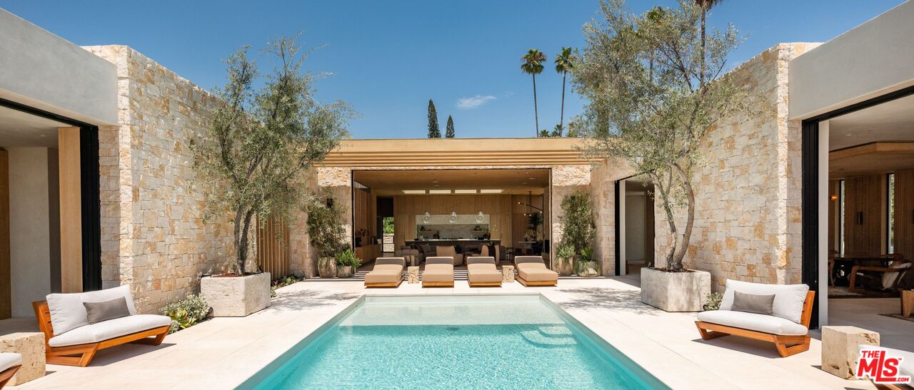 1039 Wallace Ridge Beverly Hills, CA 90210 - Photo 28 of 56 a view of a patio with couches table and chairs and potted plants