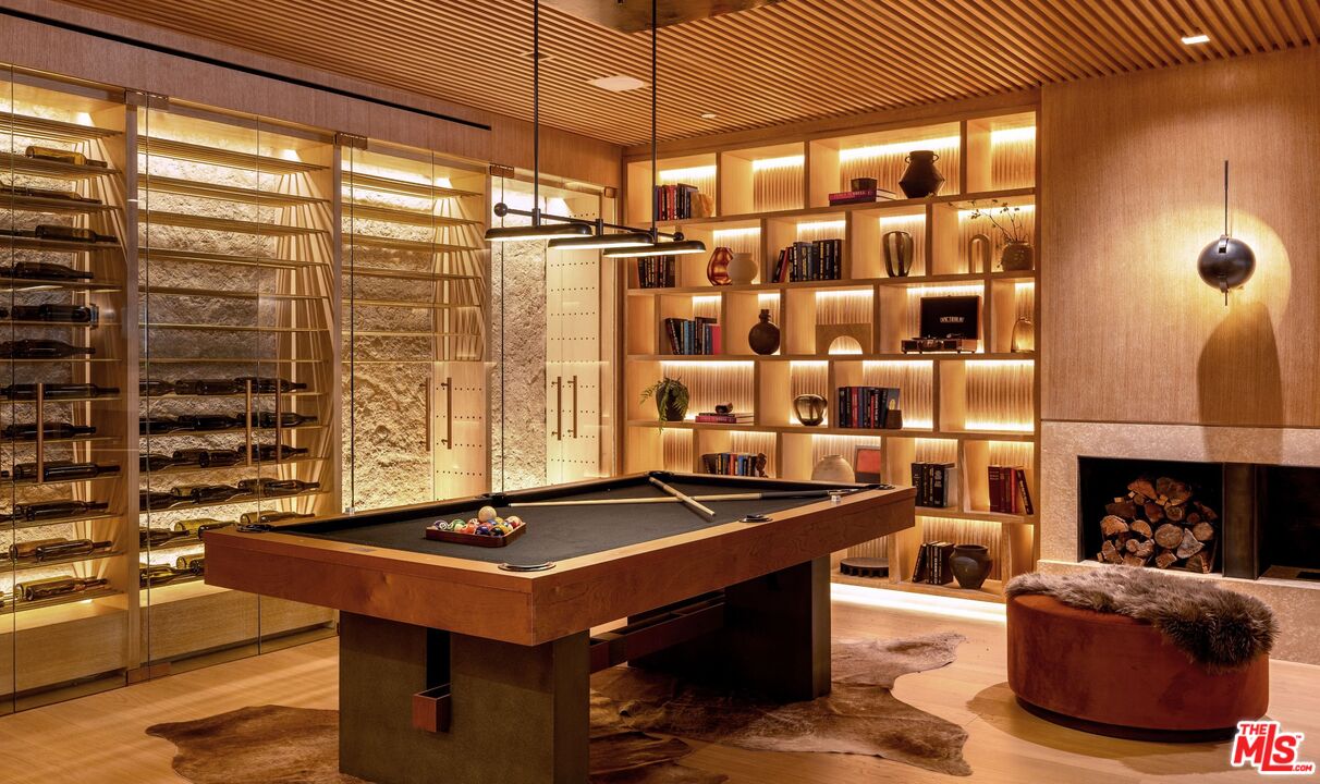 1039 Wallace Ridge Beverly Hills, CA 90210 - Photo 32 of 56 a living room with a table and a fireplace