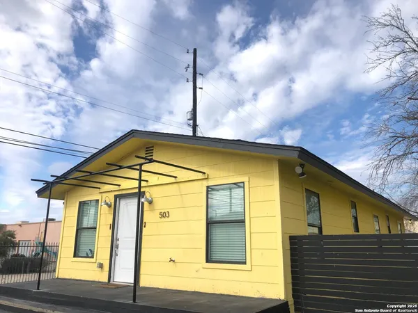a blue and yellow umbrella sitting in front of a house