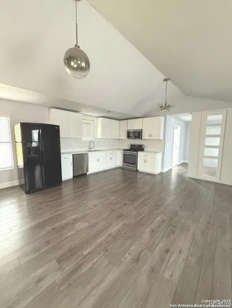 a view of empty room with wooden floor