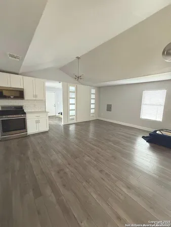 a view of empty room with wooden floor