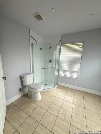 a bathroom with a toilet and a shower