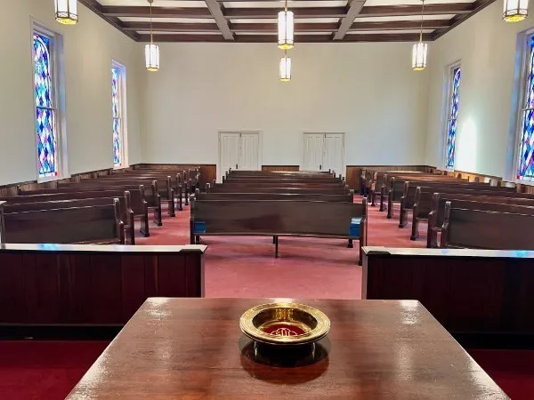 a living room with table chairs and wooden floor