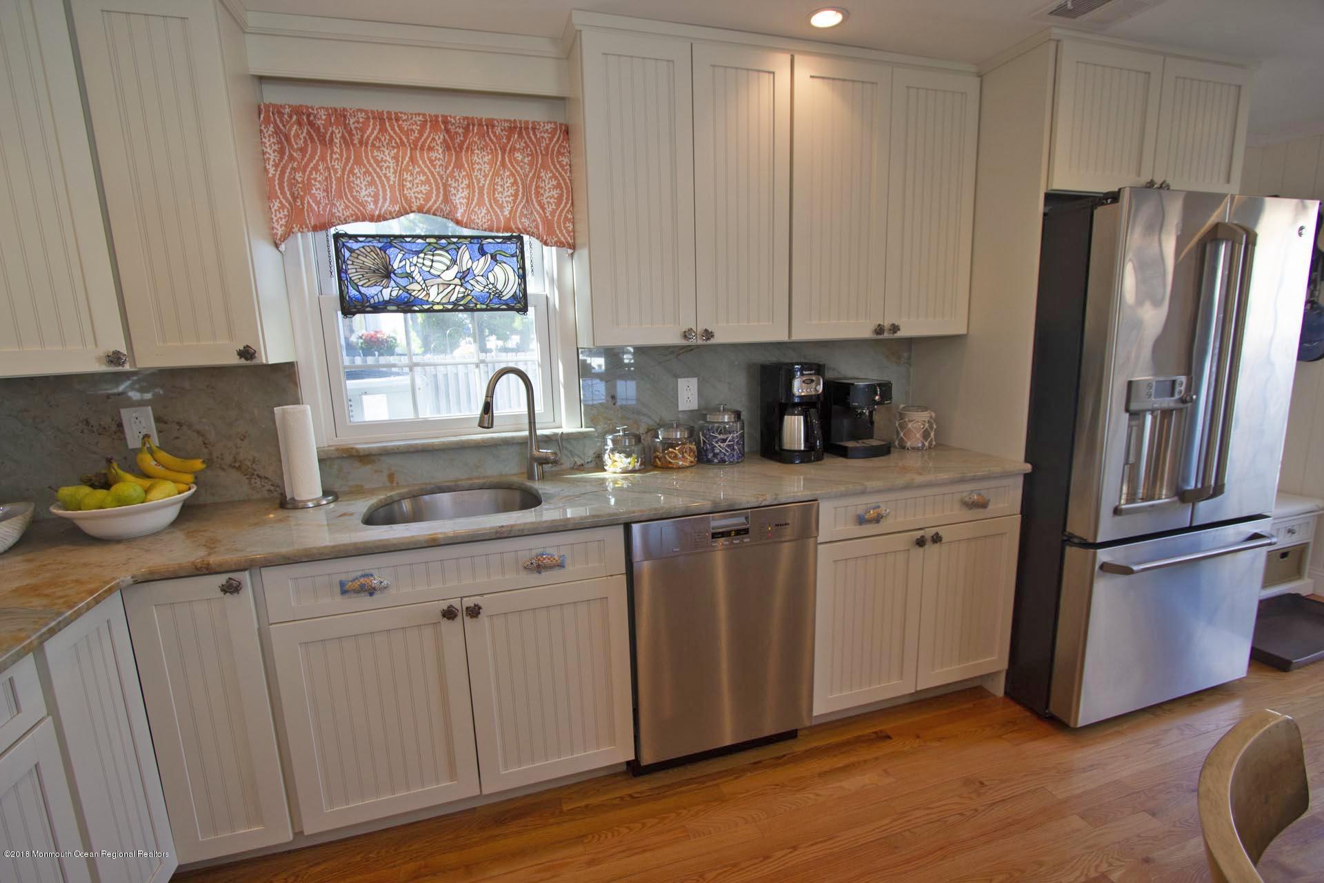 52 Fishermans Road Lavallette, NJ 08735 - Photo 12 of 74 a kitchen with stainless steel appliances granite countertop a refrigerator sink and cabinets