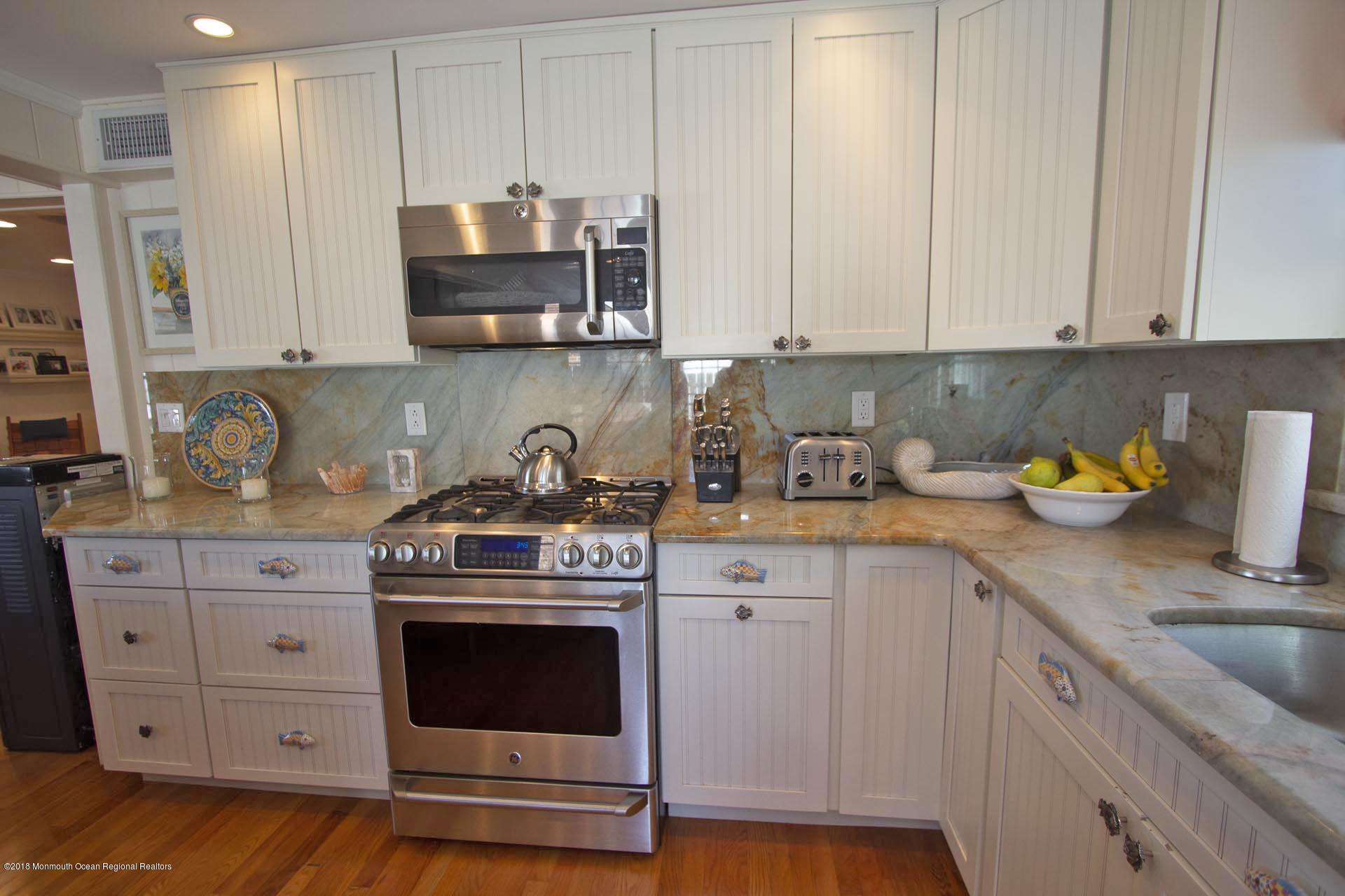 52 Fishermans Road Lavallette, NJ 08735 - Photo 13 of 74 a kitchen with stainless steel appliances granite countertop a stove a sink and a white cabinets