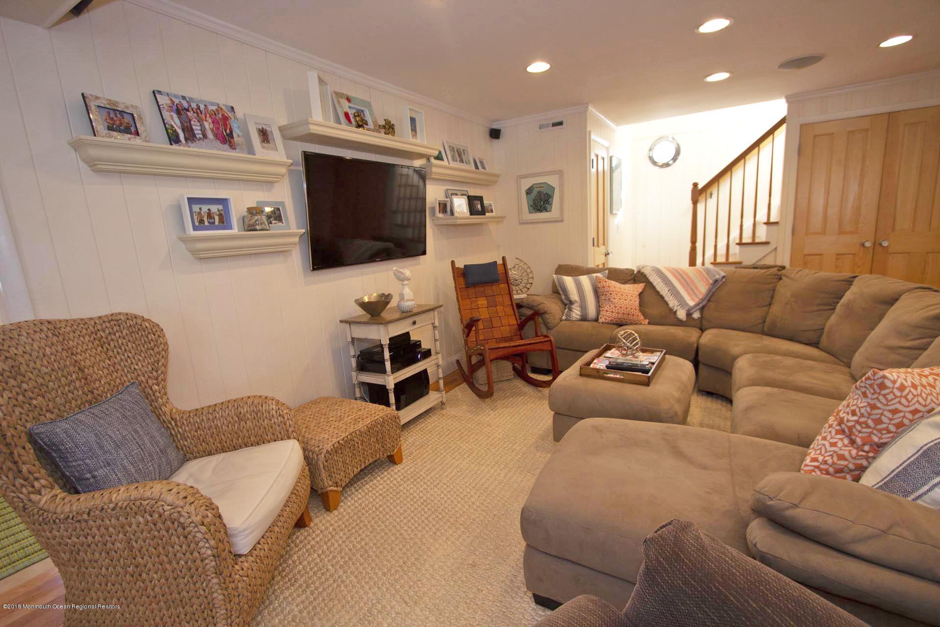 52 Fishermans Road Lavallette, NJ 08735 - Photo 20 of 74 a living room with furniture a flat screen tv and kitchen view