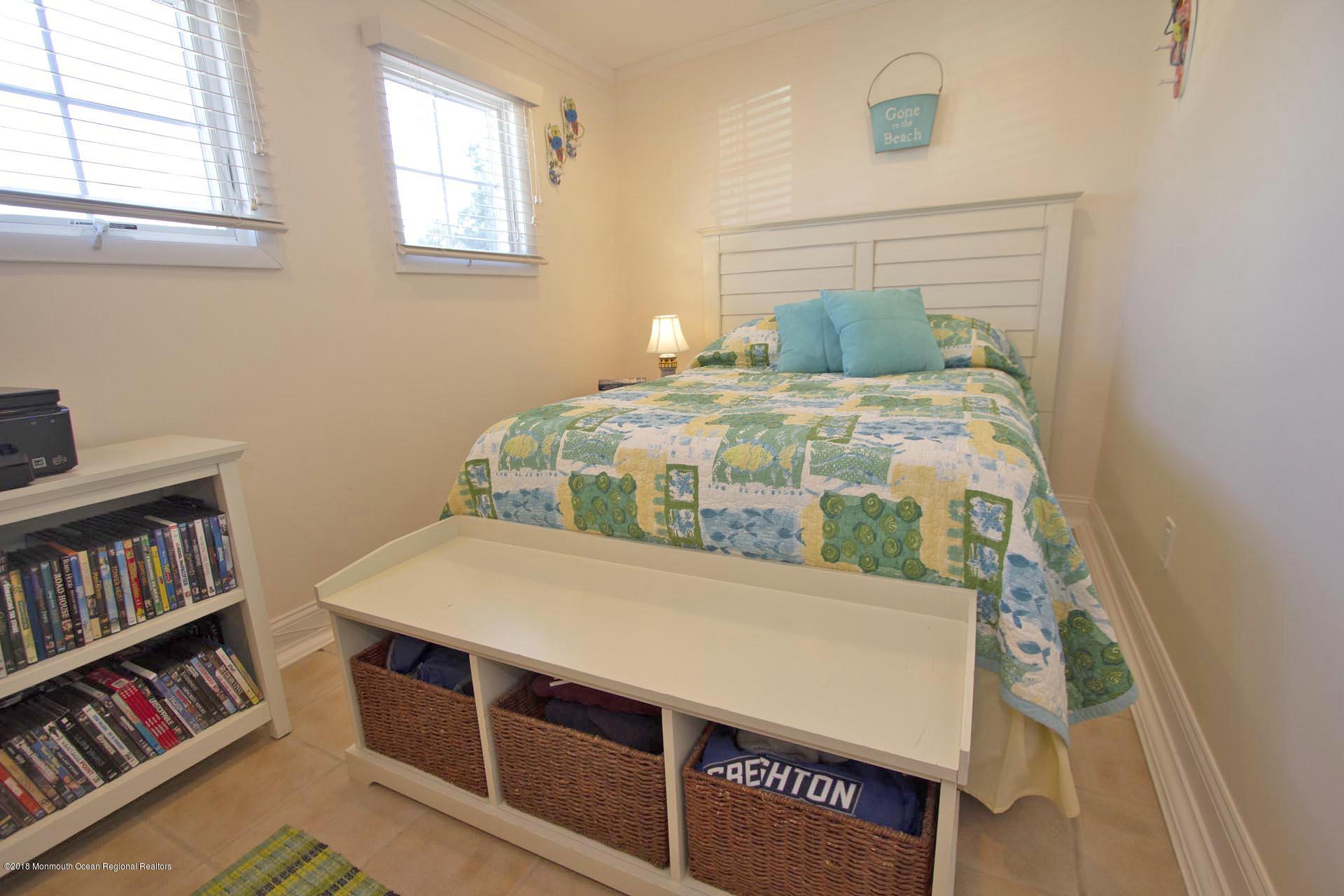 52 Fishermans Road Lavallette, NJ 08735 - Photo 23 of 74 a bedroom with a bed and a book shelf