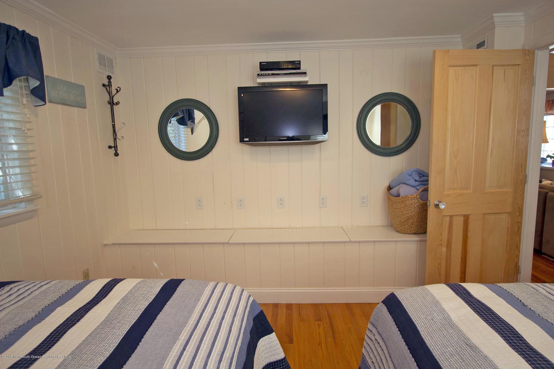 52 Fishermans Road Lavallette, NJ 08735 - Photo 26 of 74 a bedroom with a bed and a cabinets