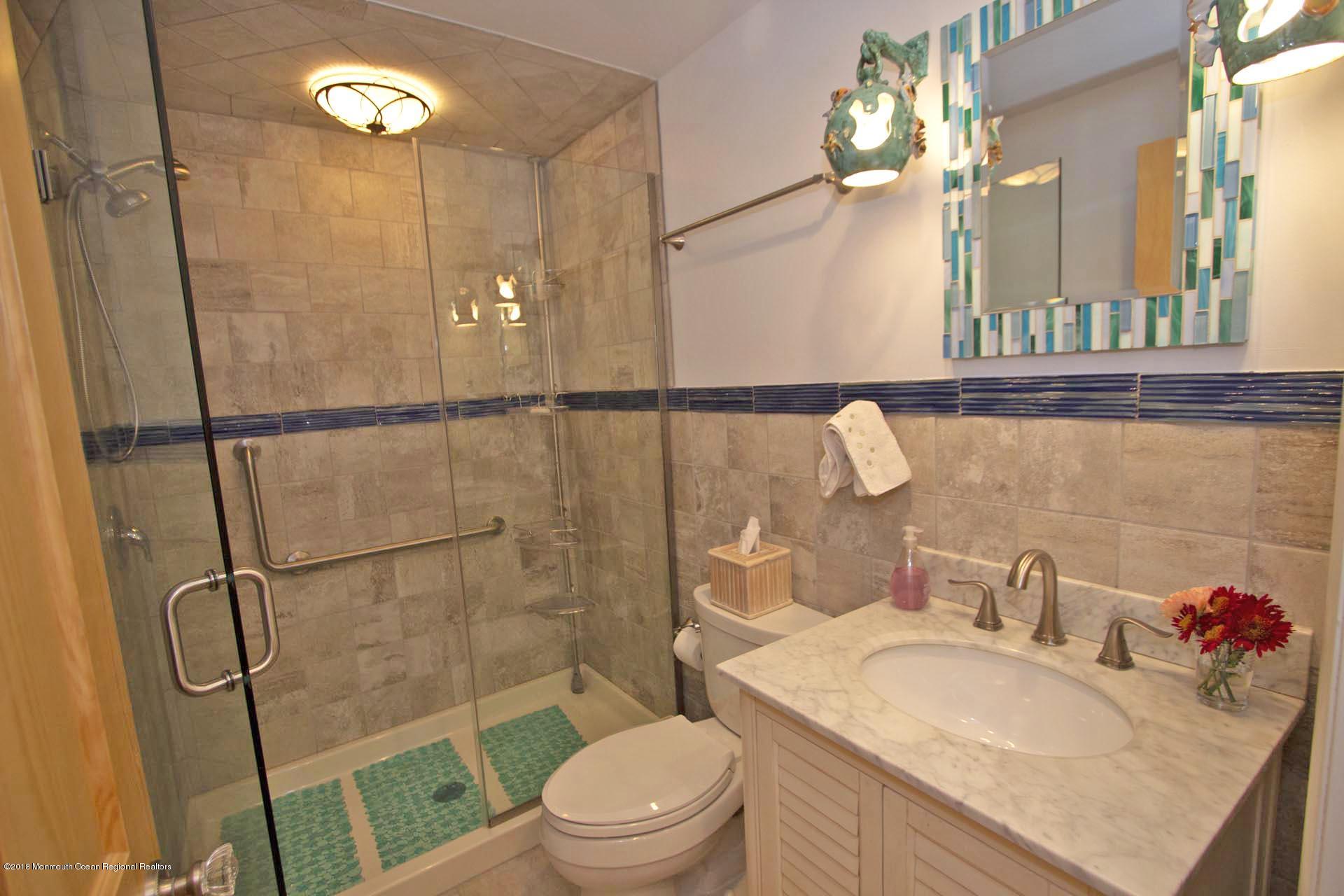 52 Fishermans Road Lavallette, NJ 08735 - Photo 27 of 74 a bathroom with a sink a toilet a mirror and shower