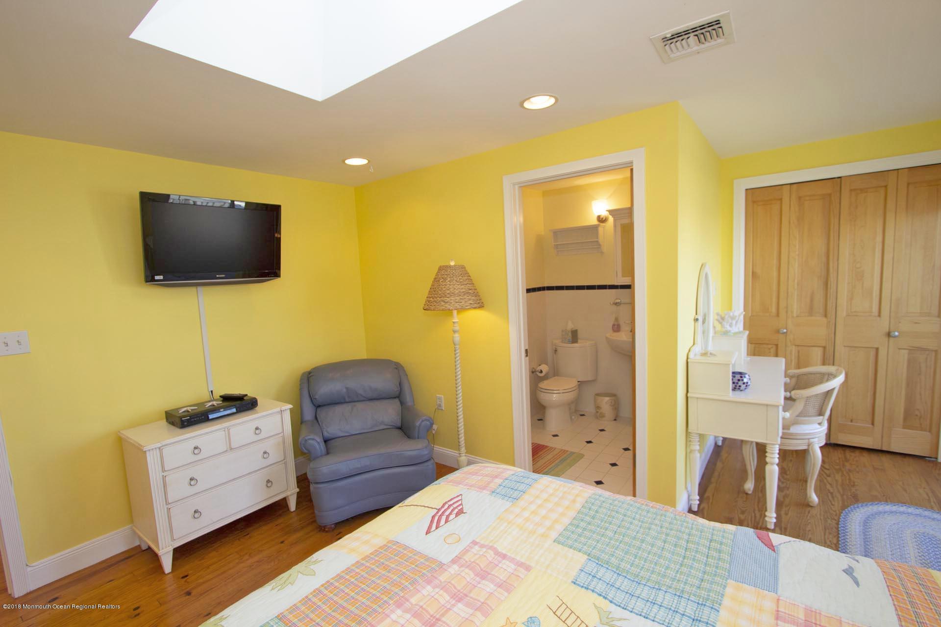 52 Fishermans Road Lavallette, NJ 08735 - Photo 36 of 74 a bedroom with a bed and wooden floor