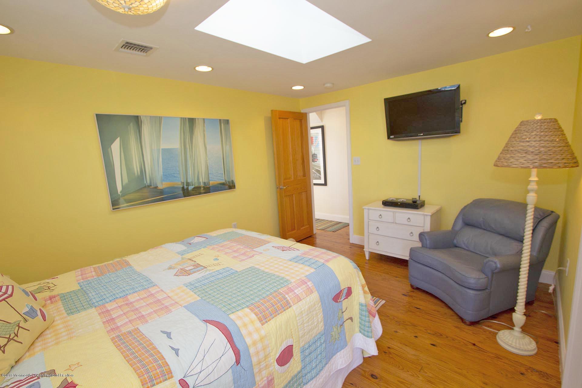 52 Fishermans Road Lavallette, NJ 08735 - Photo 37 of 74 a bedroom with a bed and couch