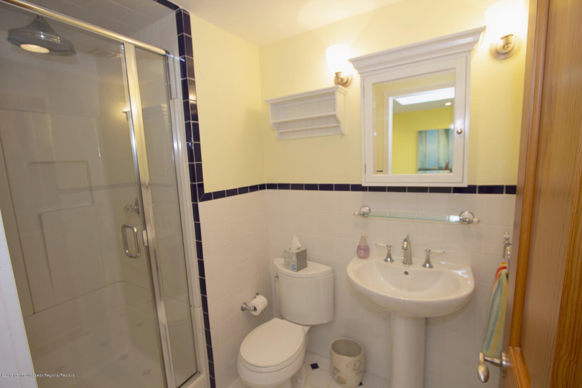 52 Fishermans Road Lavallette, NJ 08735 - Photo 41 of 74 a bathroom with a sink a mirror a toilet and shower
